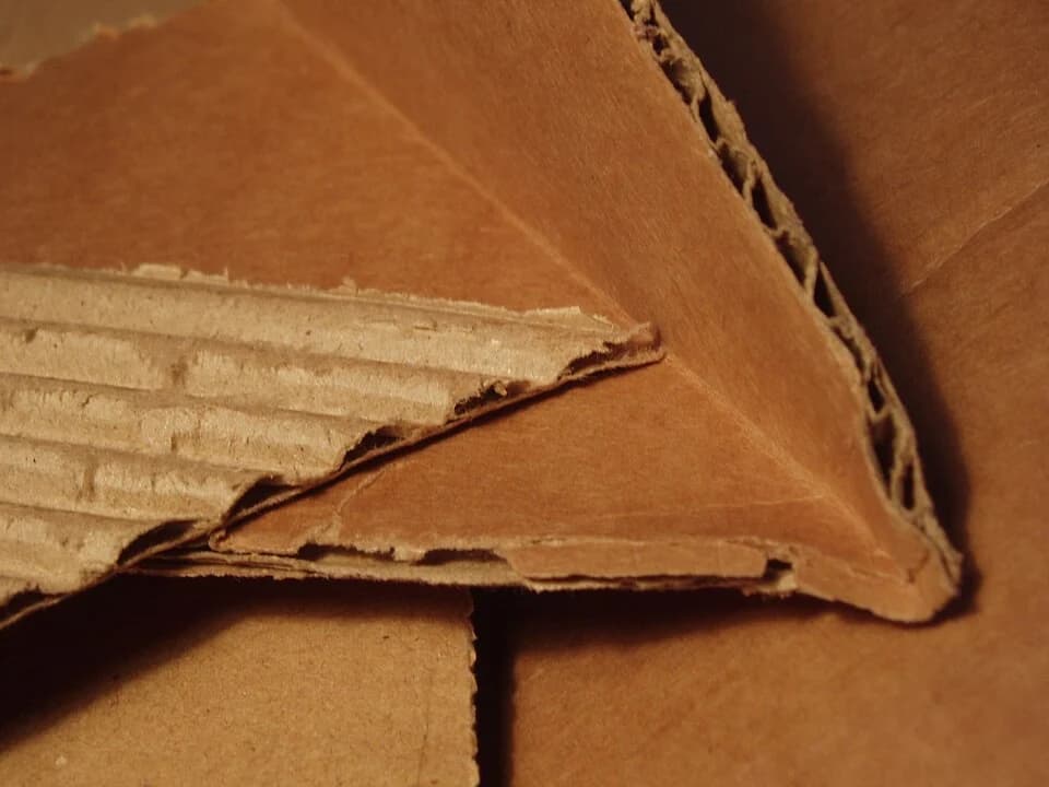 Close view of corrugated cardboard edges showing the fluted inner layer.